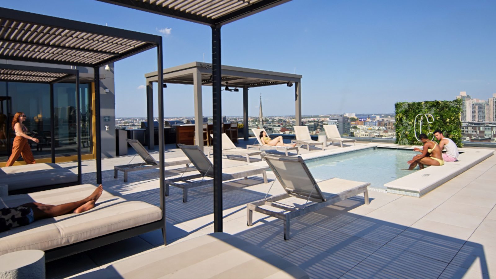 Residents lounging under rooftop cabanas