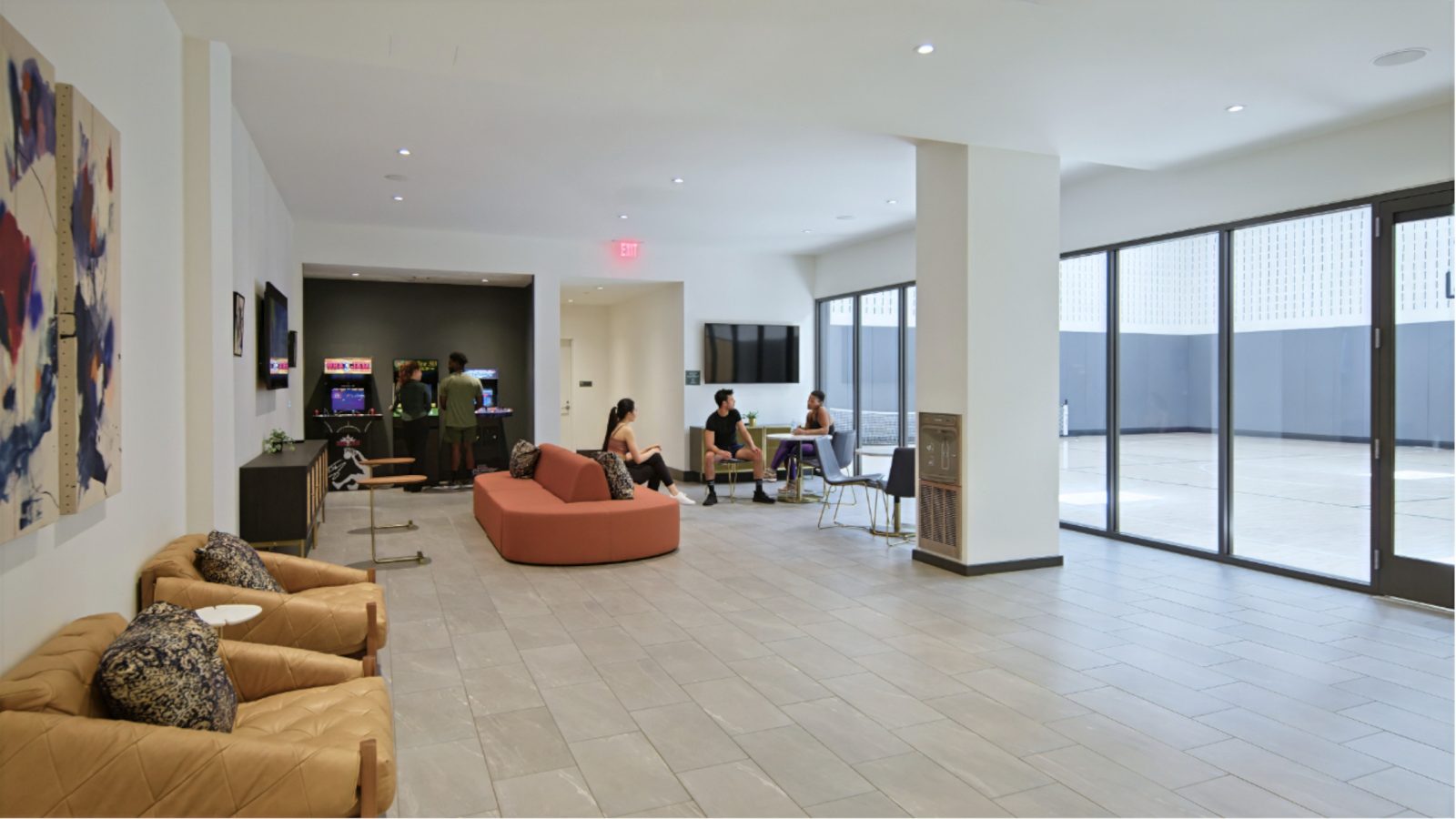 Resident seated near arcade room and basketball court