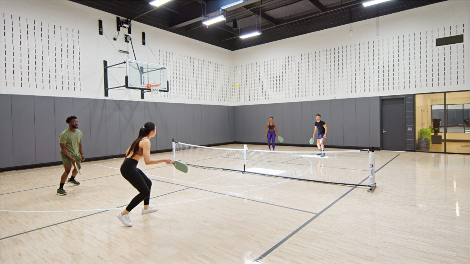 Residents playing tennis in a multi-functional court